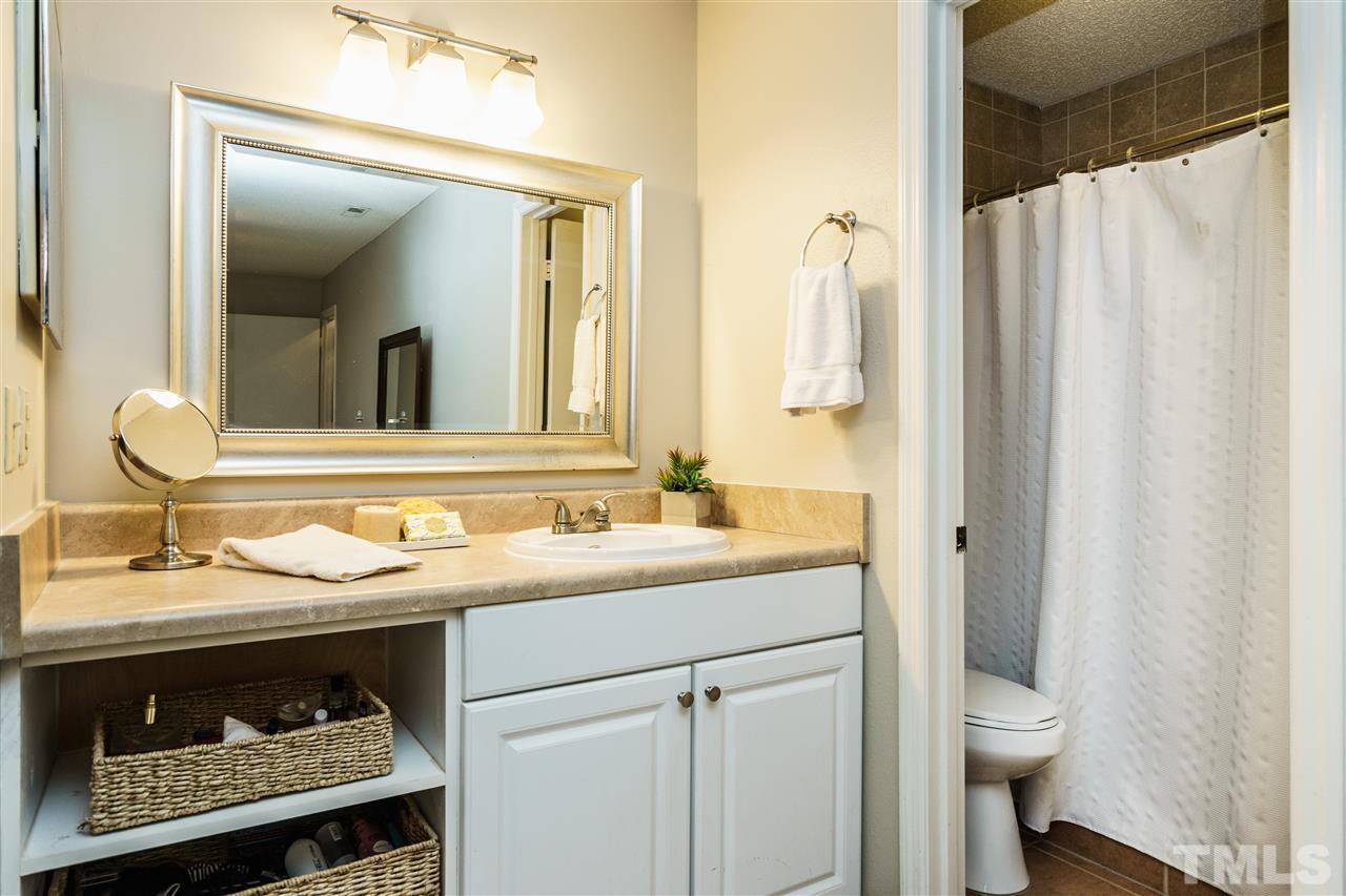 7634 Falcon Rest Circle, Unit 7634 Raleigh, NC 27615 - Photo 18 of 25 a bathroom with a granite countertop sink toilet and mirror