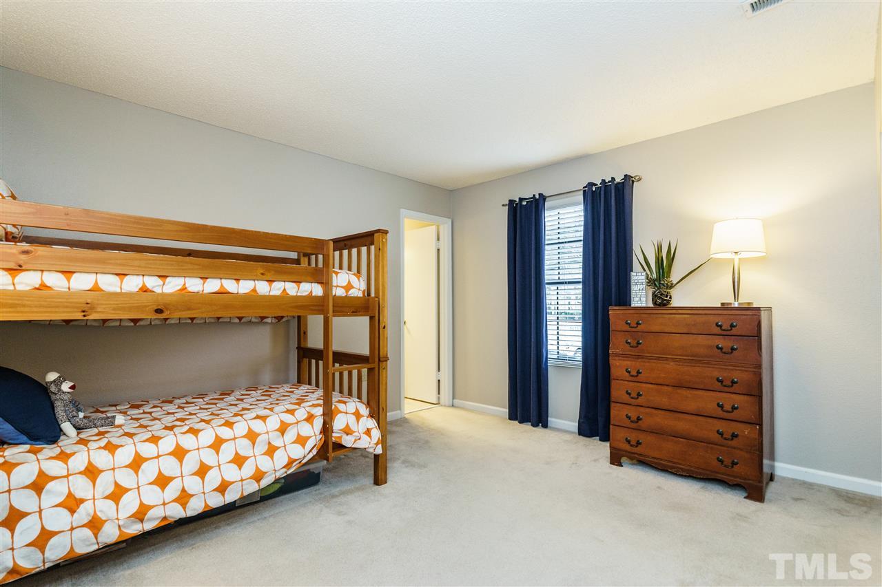 7634 Falcon Rest Circle, Unit 7634 Raleigh, NC 27615 - Photo 19 of 25 a bedroom with a bed and a window
