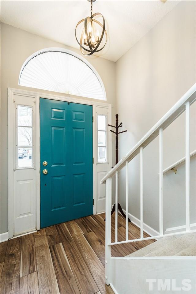 7634 Falcon Rest Circle, Unit 7634 Raleigh, NC 27615 - Photo 3 of 25 a view of a livingroom with wooden floor and staircase