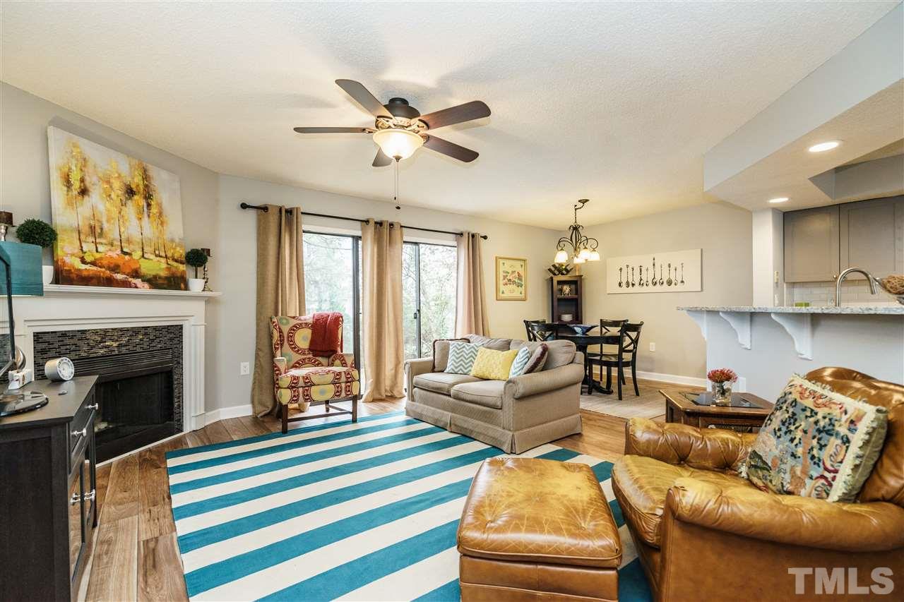 7634 Falcon Rest Circle, Unit 7634 Raleigh, NC 27615 - Photo 5 of 25 a living room with furniture fireplace and a flat screen tv