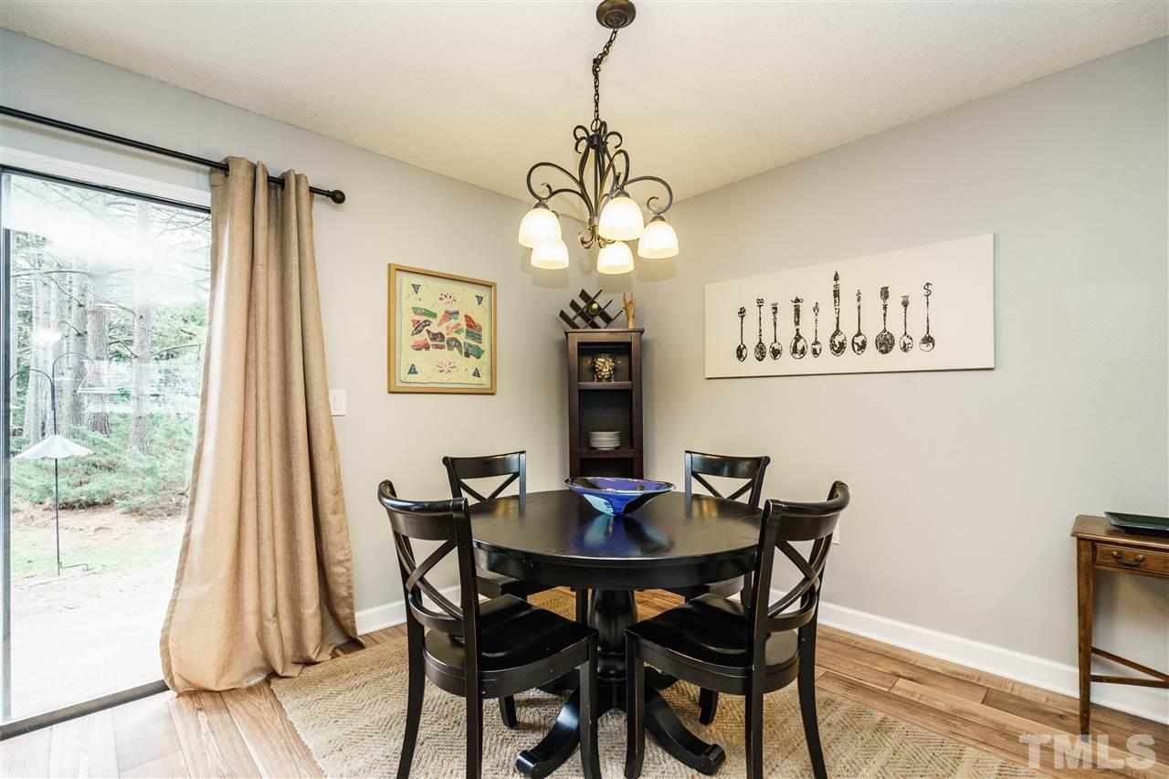 7634 Falcon Rest Circle, Unit 7634 Raleigh, NC 27615 - Photo 9 of 25 a dining room with wooden floor and breakfast area