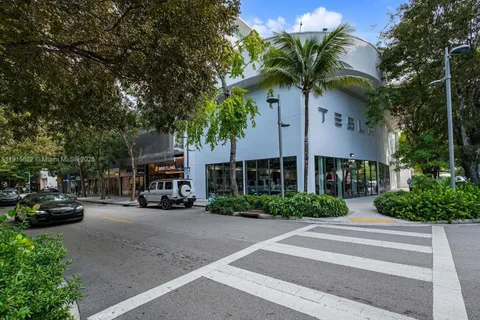 a couple of cars parked in front of a building