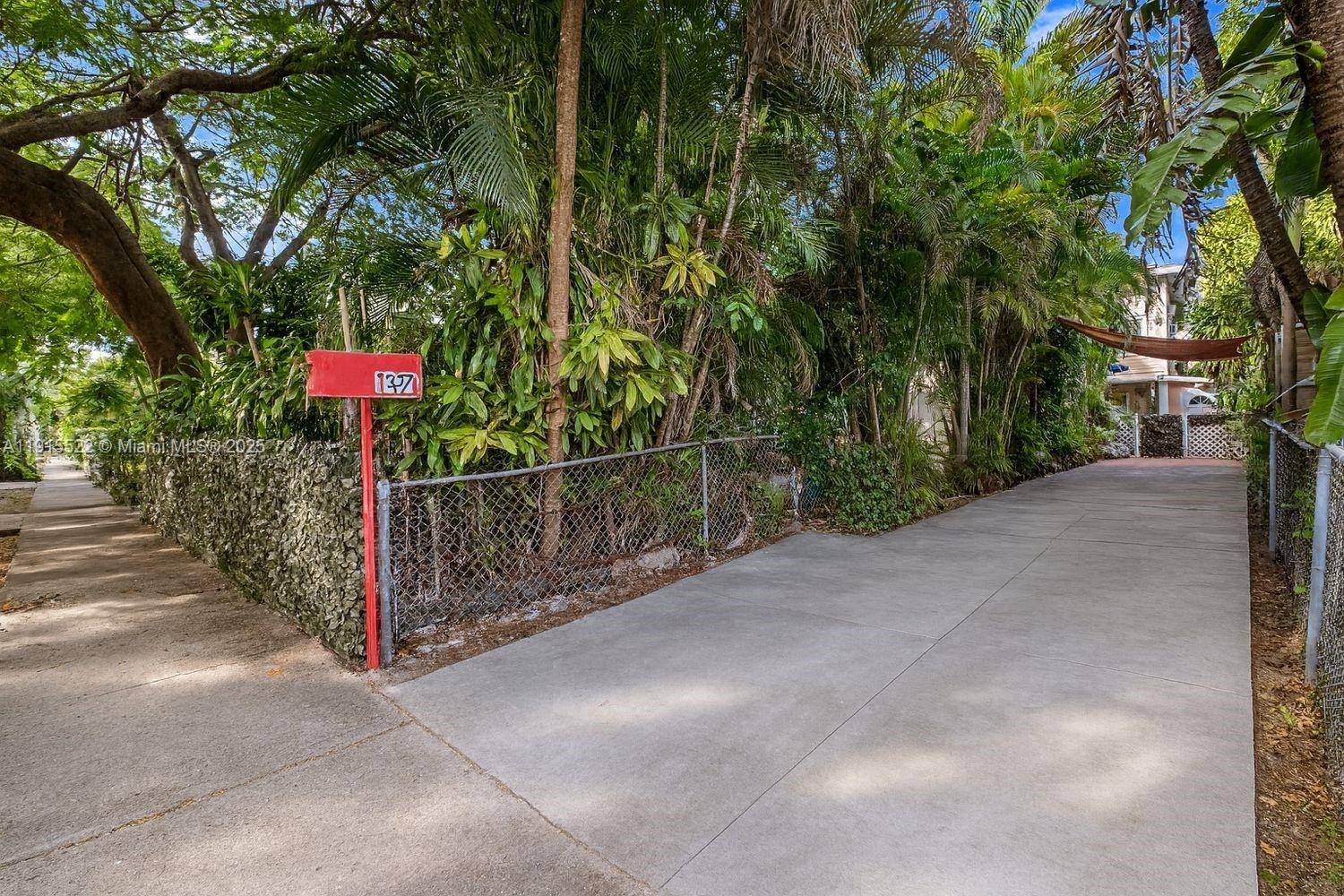 137 Northeast 46th Street Miami, FL 33137 - Photo 3 of 12 a view of a street with large trees
