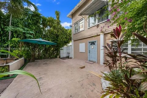 a view of a house with a yard and sitting area