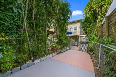 a front view of a house with a yard and fountain