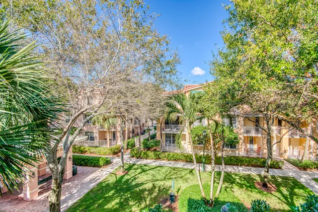 a kitchen with granite countertop a stove a sink and a microwave