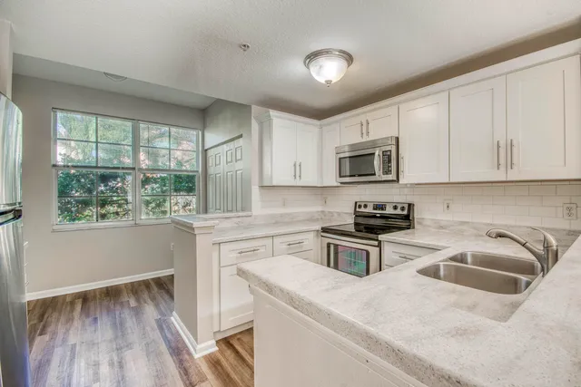 a view of a livingroom with wooden floor and a window