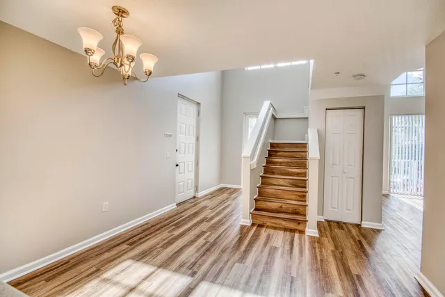 a view of an empty room and wooden floor