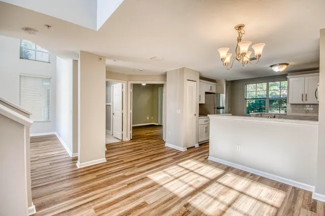 a kitchen with granite countertop white cabinets sink and stainless steel appliances