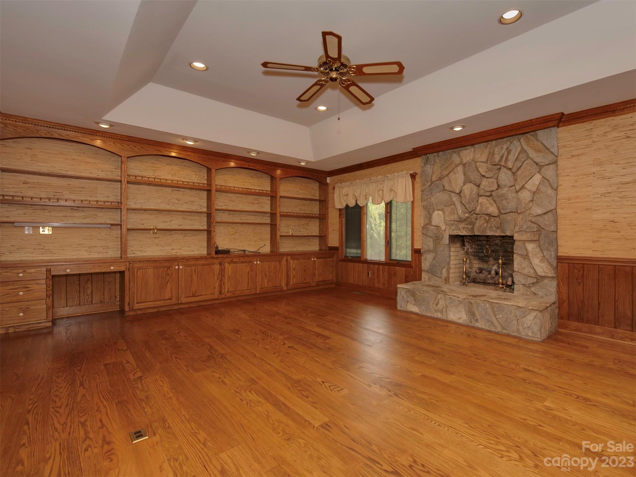 136 Patrick Road Gastonia, NC 28056 - Photo 9 of 22 a view of a livingroom with a fireplace a ceiling fan and wooden floor