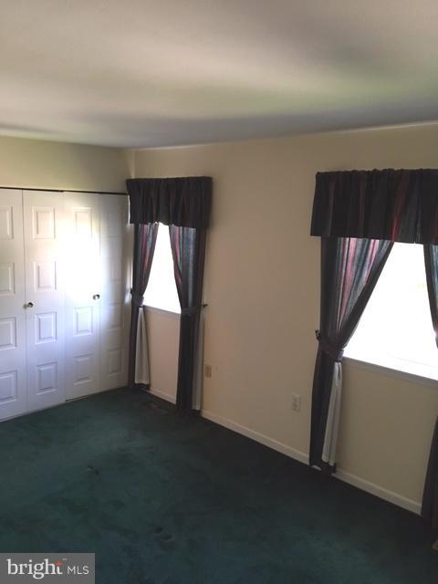 9331 Pan Ridge Road Baltimore, MD 21234 - Photo 6 of 8 an empty room with windows