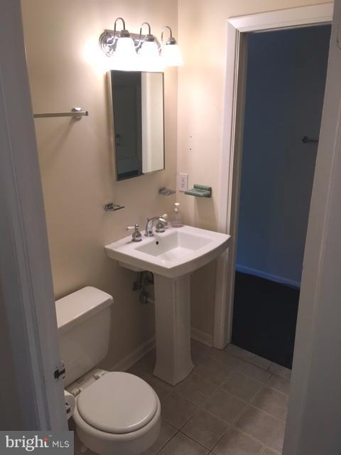 9331 Pan Ridge Road Baltimore, MD 21234 - Photo 8 of 8 a bathroom with a toilet a sink and mirror