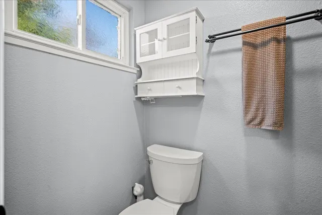 a bathroom with a toilet and a shower