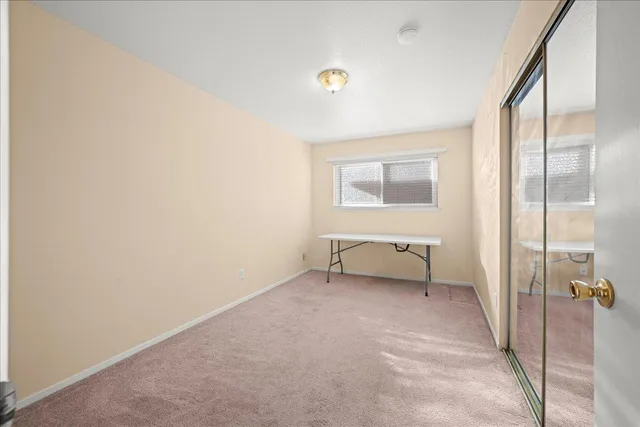 a view of a livingroom with a couch and a window