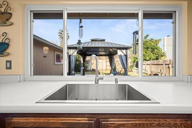 a view of a kitchen sink with a window