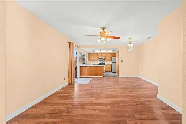 a view of a kitchen with a sink and a refrigerator