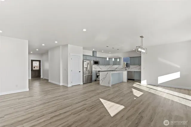a view of kitchen with wooden floor and electronic appliances
