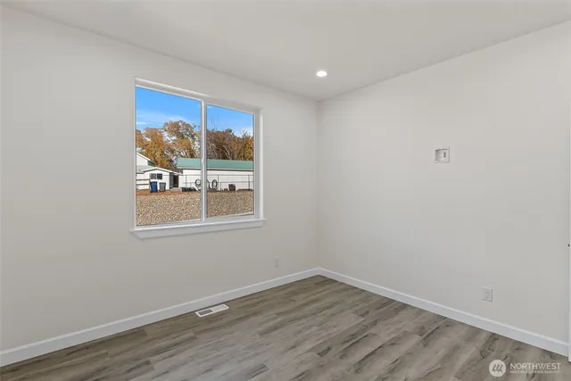 a view of a room with wooden floor and window