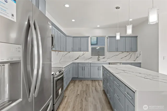 a kitchen with a sink refrigerator and microwave