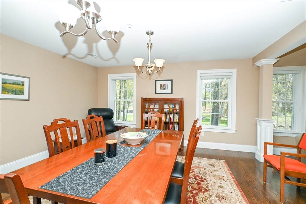 60 Harding Street, Unit C Medfield, MA 02052 - Photo 17 of 41 a living room with furniture a rug and a chandelier