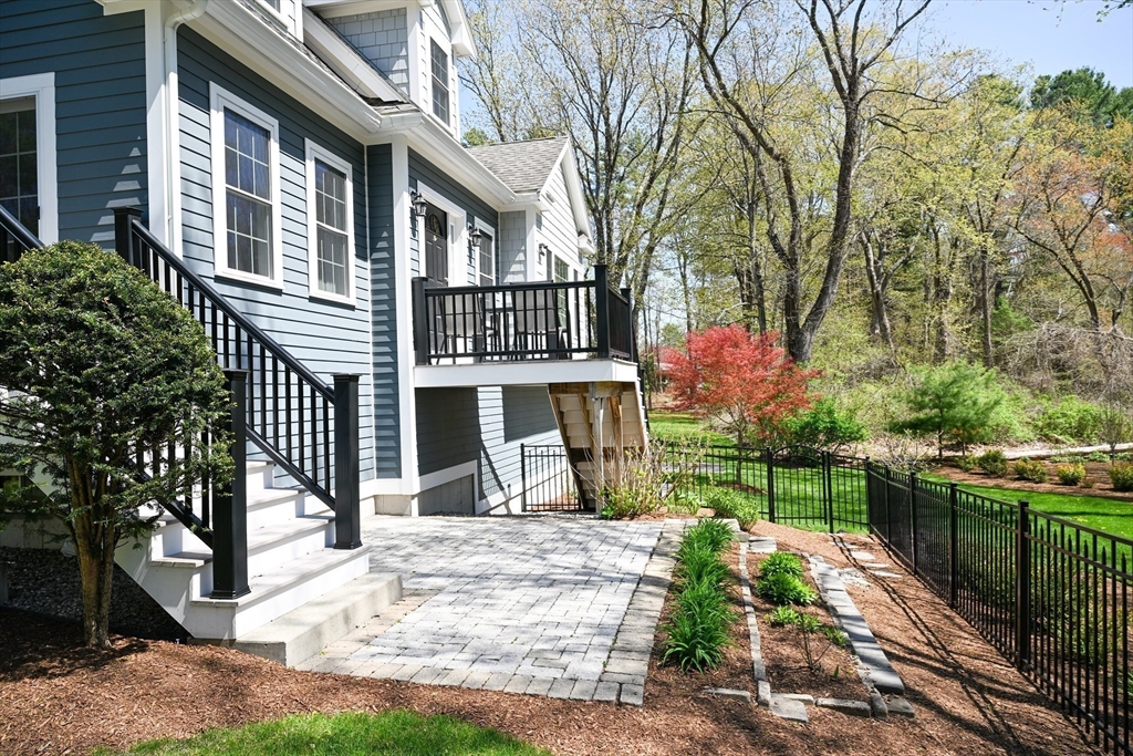 60 Harding Street, Unit C Medfield, MA 02052 - Photo 2 of 41 a front view of a house with a yard table and chairs