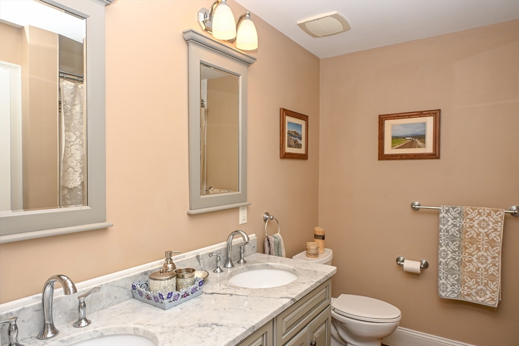 60 Harding Street, Unit C Medfield, MA 02052 - Photo 26 of 41 a bathroom with a granite countertop sink mirror vanity and toilet