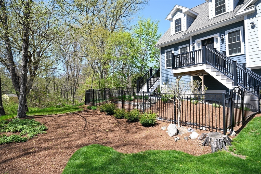 60 Harding Street, Unit C Medfield, MA 02052 - Photo 32 of 41 a view of a brick house with a yard plants and large tree