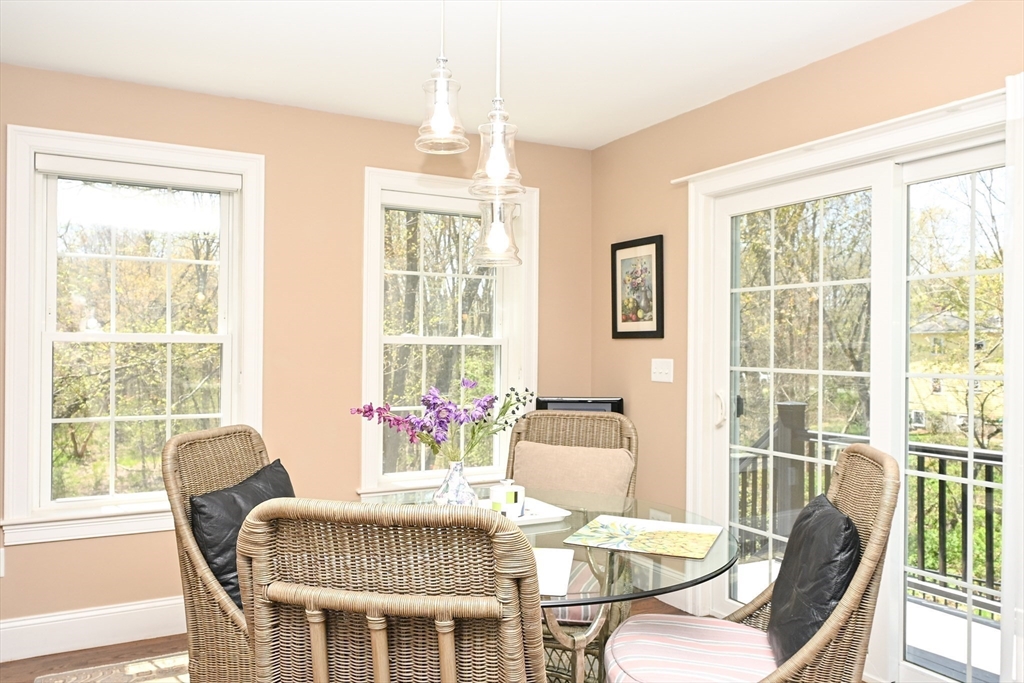 60 Harding Street, Unit C Medfield, MA 02052 - Photo 10 of 41 a dining room with furniture a chandelier and wooden floor