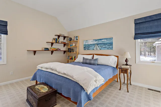 a bedroom with a bed and dresser