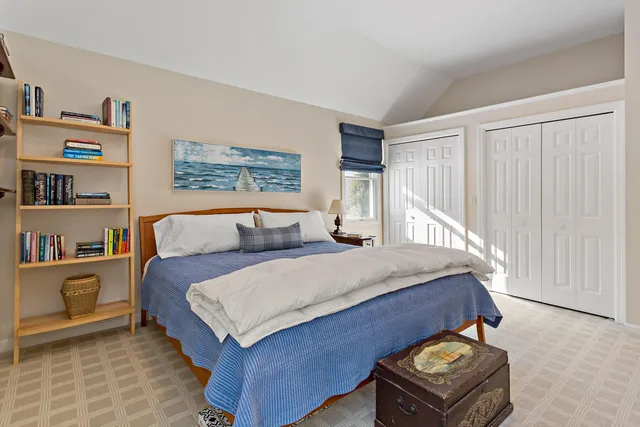 a bedroom with a bed and a book shelf