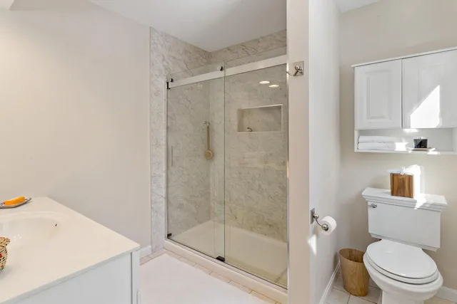 a bathroom with a shower a toilet and a sink