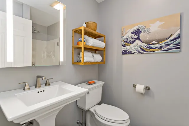 a bathroom with a sink a mirror and toilet