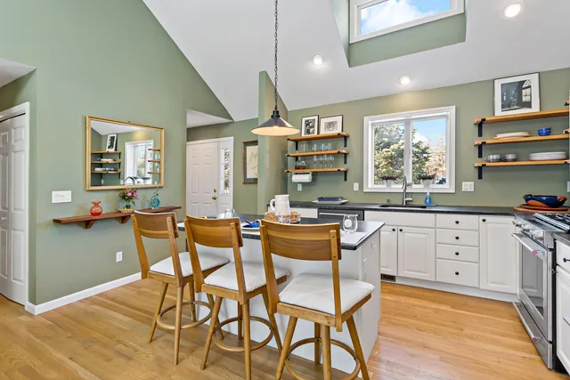a kitchen with granite countertop white cabinets and stainless steel appliances