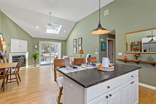 a kitchen with a table chairs and a chandelier