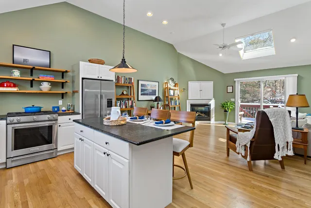 a kitchen with stainless steel appliances granite countertop a stove and a refrigerator