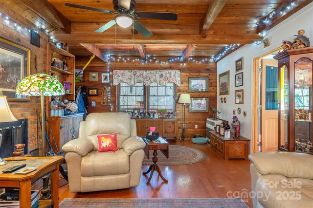 a living room with patio furniture and a chandelier