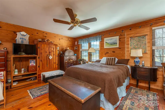 a bed room with a bed and a television