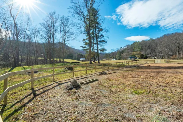 a view of a yard with wooden fence