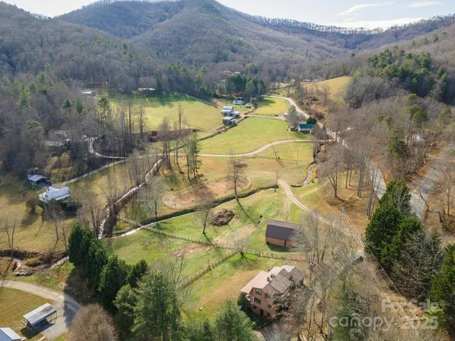 an aerial view of residential houses with outdoor space