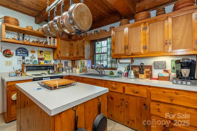 a kitchen with stainless steel appliances granite countertop a sink a stove and a refrigerator