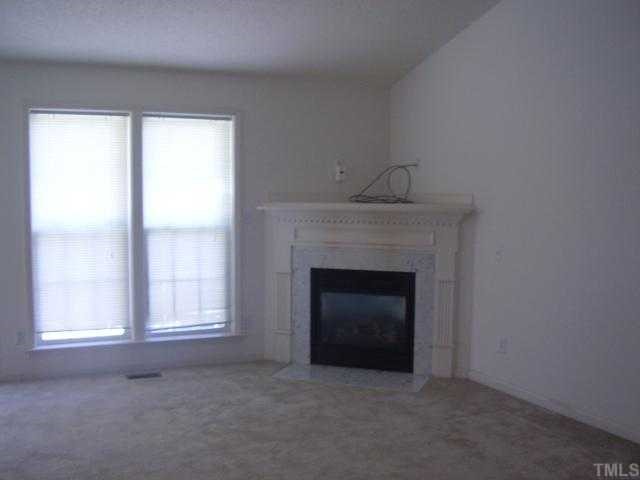 7113 Missionary Ridge Drive Raleigh, NC 27610 - Photo 2 of 3 a room with fireplace and window
