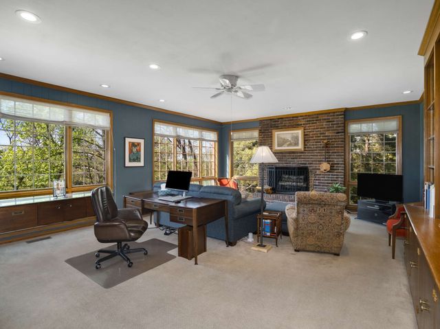 a view of a livingroom with workspace and a window