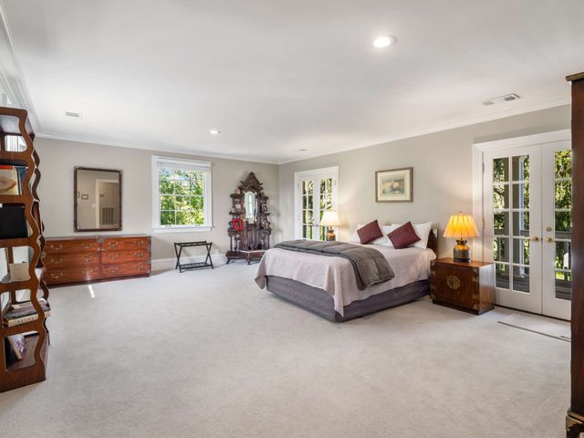 a spacious bedroom with a bed and a couch