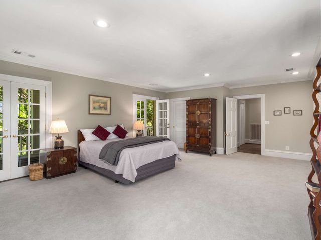 a spacious bedroom with a bed and furniture