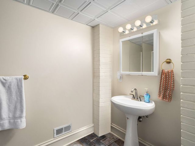a bathroom with a sink and mirror