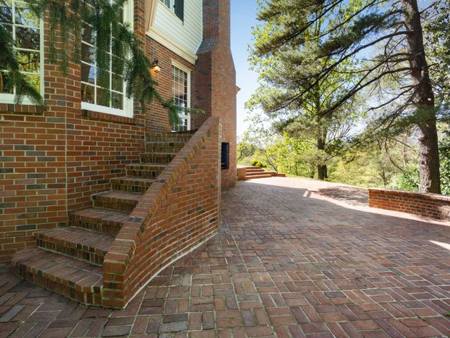 a view of a patio with a dining table and chairs with wooden fence