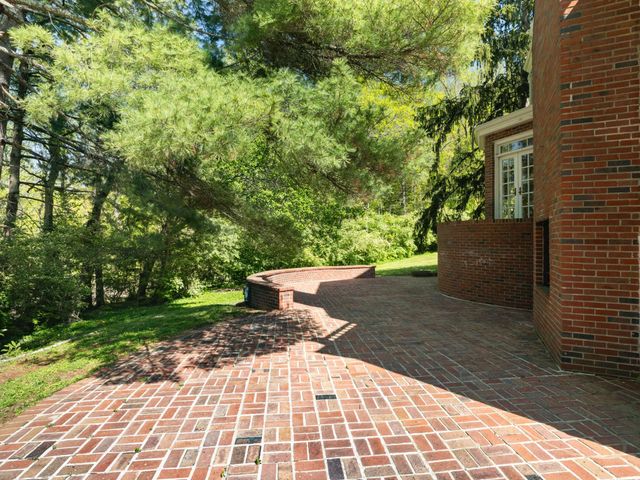 a view of house with yard and sitting area