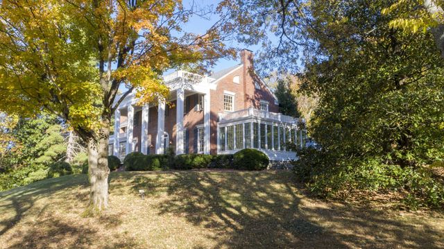 front view of a house with a tree