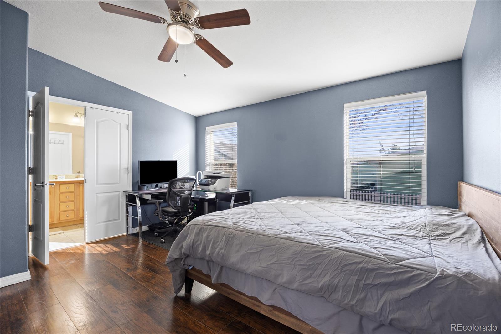 6160 Mallow Green, Unit 272 Frederick, CO 80530 - Photo 6 of 14 a bedroom with a bed and a flat screen tv