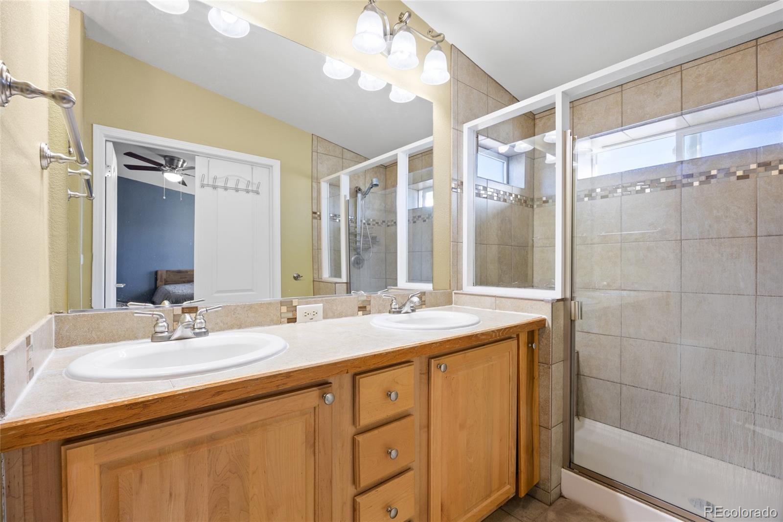 6160 Mallow Green, Unit 272 Frederick, CO 80530 - Photo 7 of 14 a bathroom with double vanity sinks and a mirror